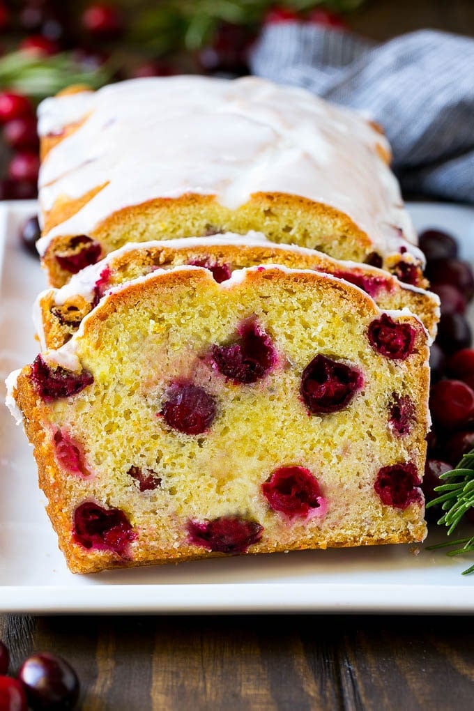 Cranberry Bread Recipe | Cranberry Loaf | Cranberry Orange Bread #cranberry #bread #baking #dessert #fall #jonep Sliced cranberry bread on a serving plate.