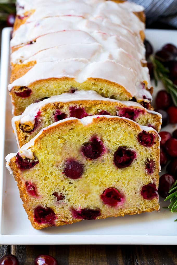Cranberry Bread Recipe | Cranberry Loaf | Cranberry Orange Bread #cranberry #bread #baking #dessert #fall #jonep Slices of cranberry bread topped with orange glaze.