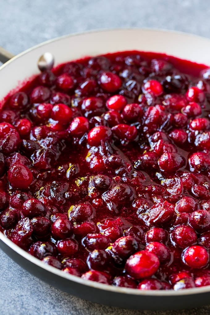 Cranberry Orange Sauce Recipe | Homemade Cranberry Sauce | Fresh Cranberry Sauce #cranberry #orange #fall #thanksgiving #sauce #dinner #jonep Cranberry orange sauce simmering in a skillet.