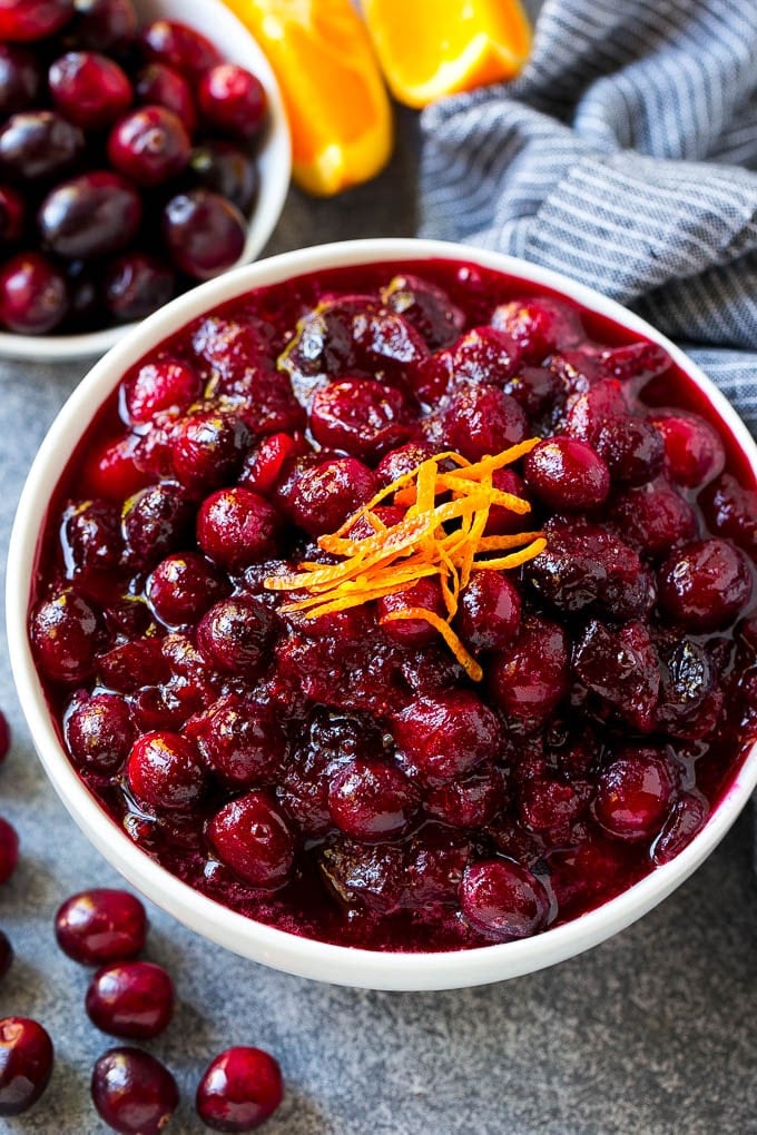 Cranberry Orange Sauce Recipe | Homemade Cranberry Sauce | Fresh Cranberry Sauce #cranberry #orange #fall #thanksgiving #sauce #dinner #jonep Cranberry orange sauce, topped with fresh orange zest in a serving bowl.