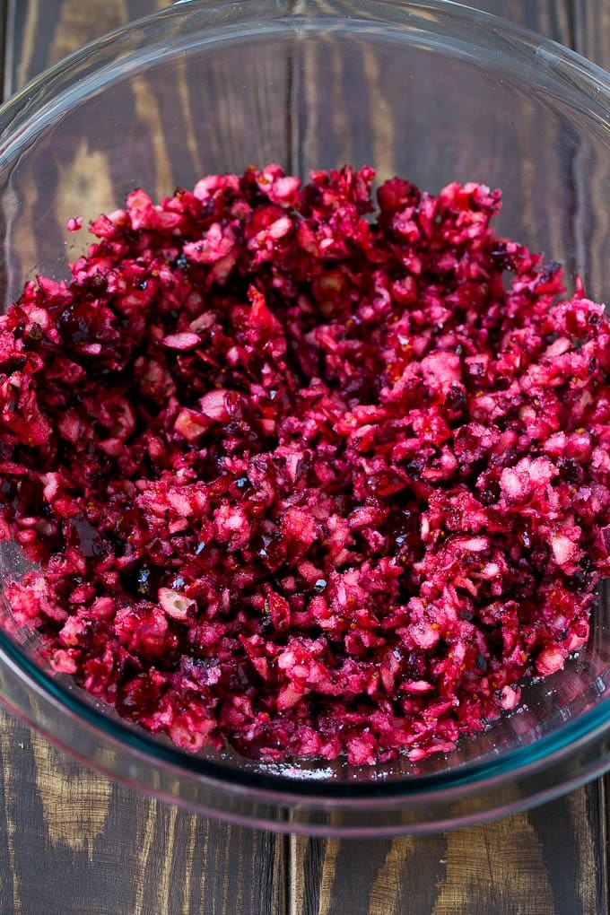 Cranberry Salad Recipe | Fluff Salad #cranberry #salad #fall #dinner #jonep #thanksgiving Chopped cranberries mixed with sugar in a bowl.