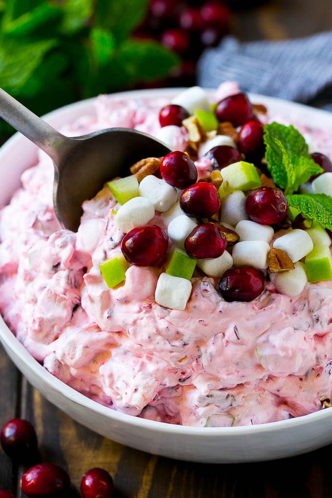 Cranberry Salad Recipe | Fluff Salad #cranberry #salad #fall #dinner #jonep #thanksgiving Cranberry salad with a serving spoon in it.