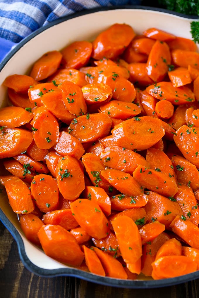 Glazed Carrots Recipe | Brown Sugar Carrots | Carrot Side Dish #carrots #brownsugar #sidedish #glutenfree #thanksgiving #fall #dinner #jonep A skillet of glazed carrots with brown sugar and butter sauce.