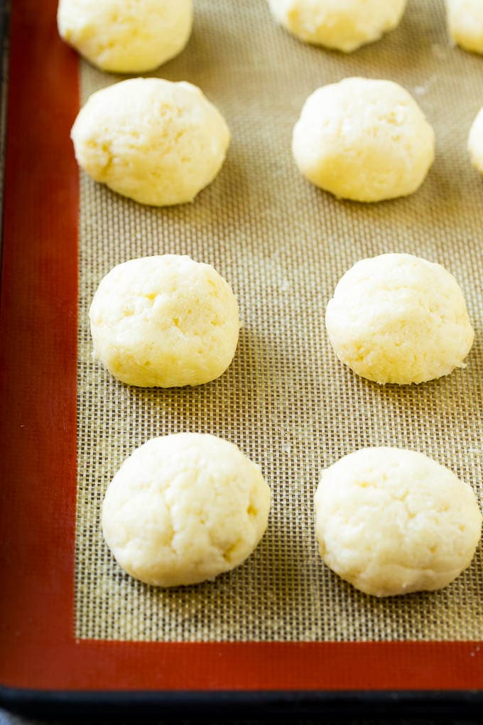 Gooey Butter Cookies Recipe | Cake Mix Cookies | Sprinkle Cookies | Christmas Cookies #cookies #butter #sprinkles #christmas #dessert #baking #jonep Balls of dough on a baking sheet.