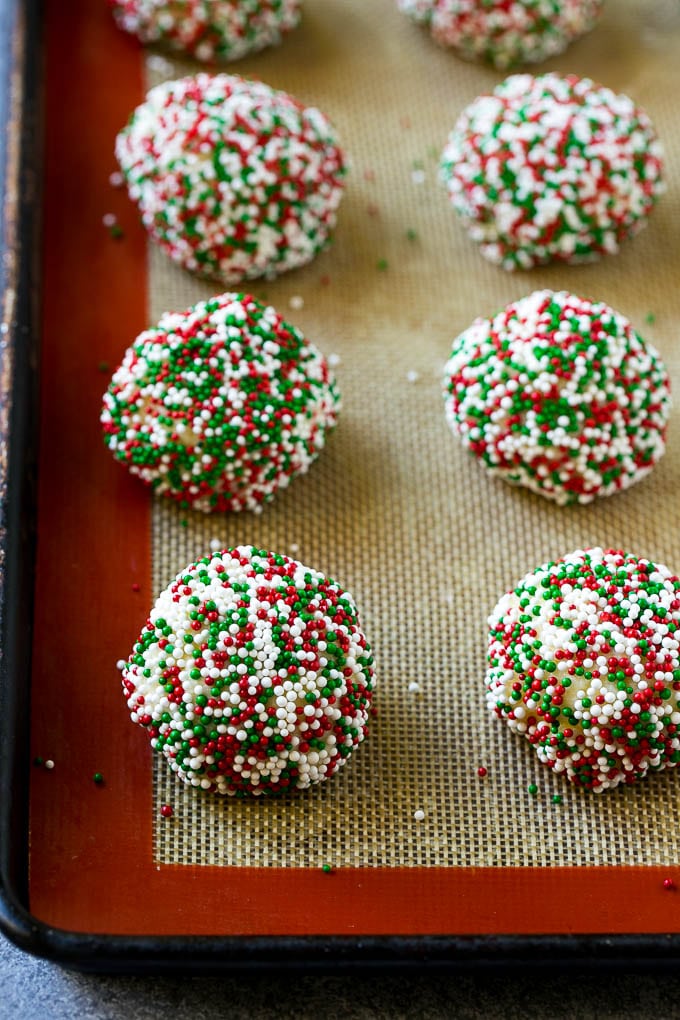 Gooey Butter Cookies Recipe | Cake Mix Cookies | Sprinkle Cookies | Christmas Cookies #cookies #butter #sprinkles #christmas #dessert #baking #jonep Balls of dough rolled in sprinkles.