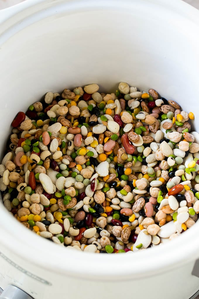 Ham and Bean Soup Recipe | Slow Cooker Ham and Bean Soup | Crockpot Ham and Bean Soup | Leftover Ham Recipe #ham #beans #soup #slowcooker #crockpot #dinner #jonep A mixture of dried beans in a crock pot.