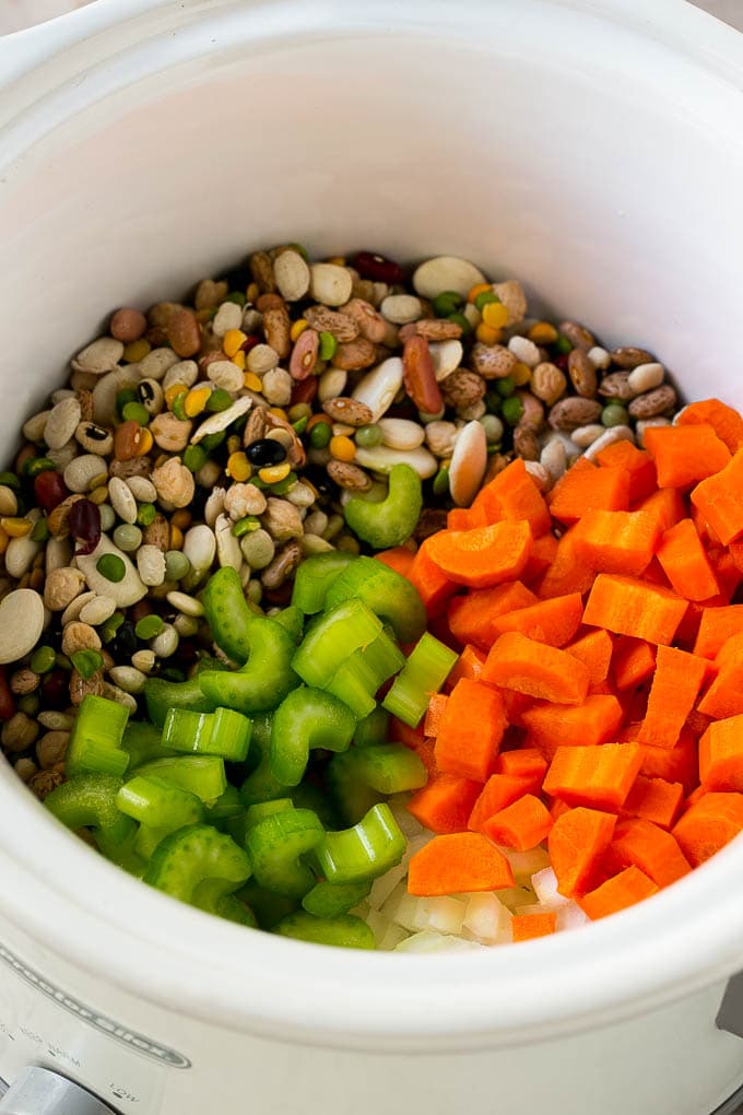 Ham and Bean Soup Recipe | Slow Cooker Ham and Bean Soup | Crockpot Ham and Bean Soup | Leftover Ham Recipe #ham #beans #soup #slowcooker #crockpot #dinner #jonep Dried beans, carrots, onions and celery in the slow cooker.