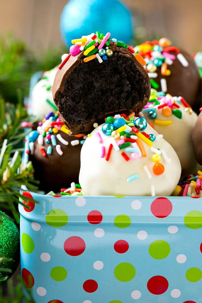 Oreo Balls Recipe | Oreo Truffles | Homemade Candy #truffles #candy #oreos #chocolate #sprinkles #dessert #christmas #jonep A cross section of an Oreo ball inside a holiday gift tin.