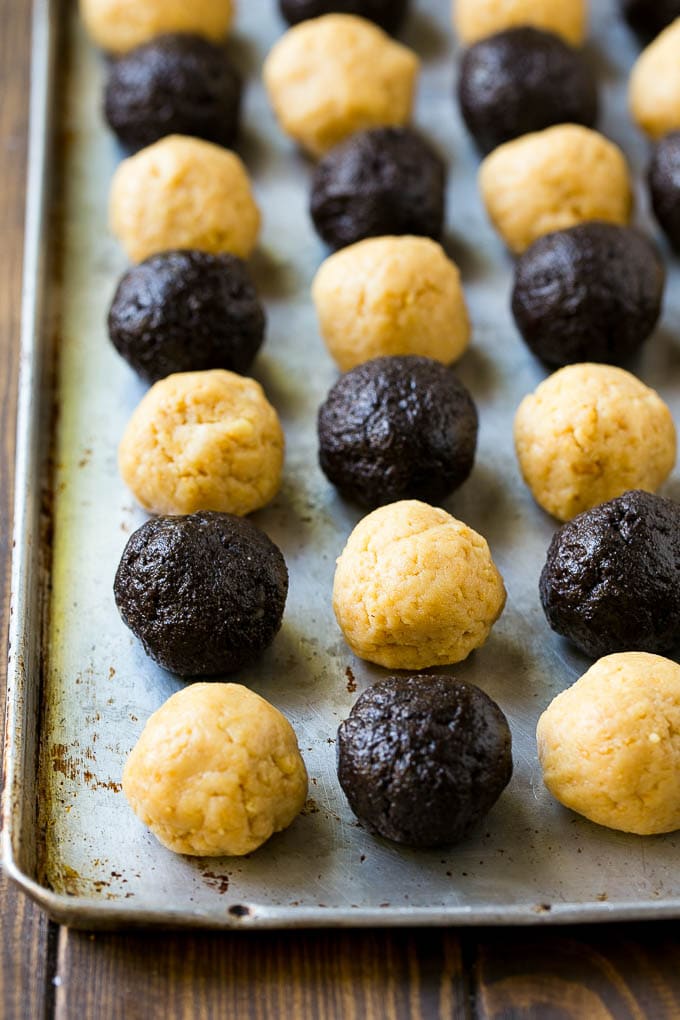 Oreo Balls Recipe | Oreo Truffles | Homemade Candy #truffles #candy #oreos #chocolate #sprinkles #dessert #christmas #jonep Oreo ball centers made from vanilla and chocolate Oreos on a sheet pan.