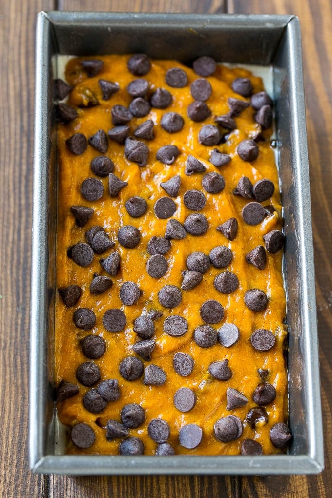 Pumpkin Chocolate Chip Bread Recipe | Pumpkin Bread | Chocolate Pumpkin Bread #pumpkin #bread #fall #chocolate #baking #dessert #jonep A loaf pan of pumpkin chocolate chip bread batter.