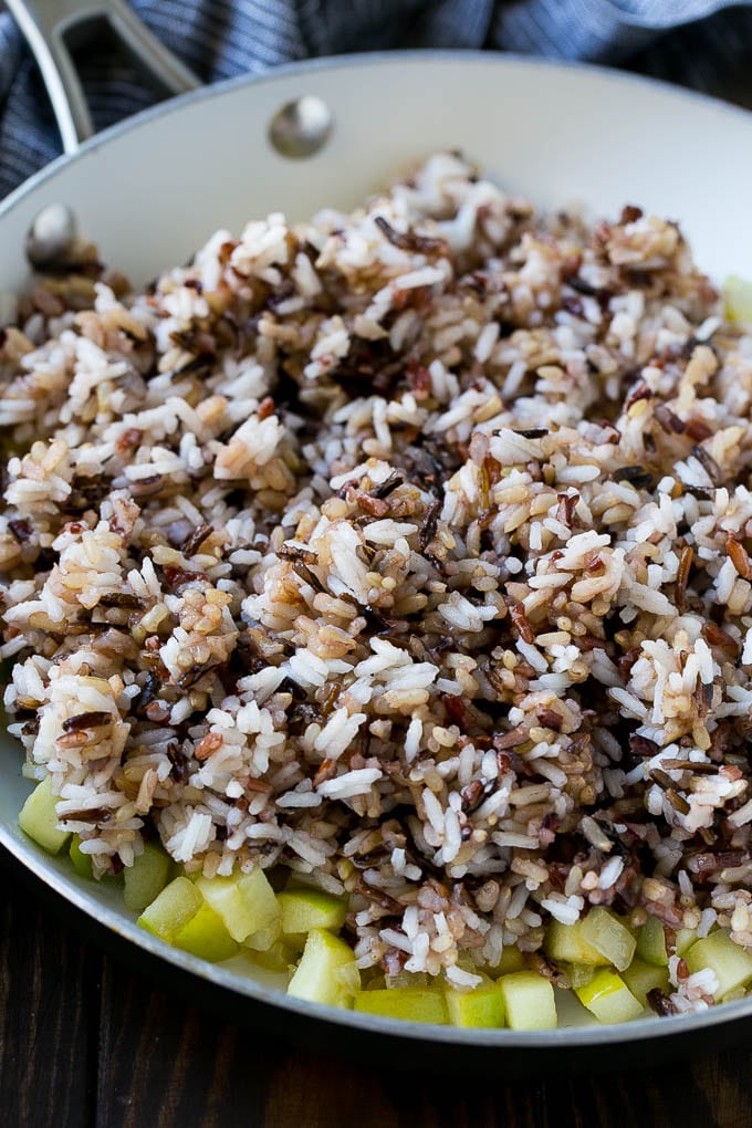 Wild Rice Pilaf Recipe | Thanksgiving Side Dish | Rice Pilaf #rice #apple #cranberry #fall #glutenfree #thanksgiving #jonep WIld rice, onions and apples in a skillet.