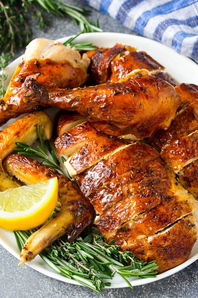 Roasted Chicken Recipe | Whole Roasted Chicken | Roast Chicken #chicken #dinner #lowcarb #keto #jonep Carved roasted chicken on a serving platter with fresh herbs.