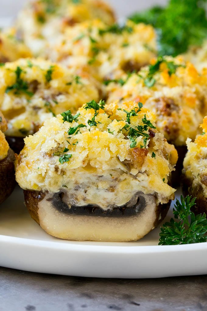 Sausage Stuffed Mushrooms Recipe | Stuffed Mushrooms | Mushroom Appetizer #mushrooms #sausage #appetizer #lowcarb #keto #jonep A cross section of a sausage stuffed mushroom on a serving platter.