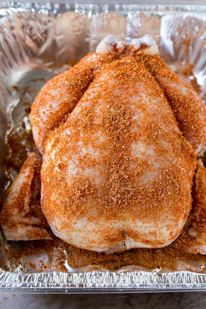 Smoked Chicken Recipe | Whole Smoked Chicken | BBQ Chicken #chicken #smoker #BBQ #dinner #jonep #glutenfree #lowcarb A raw bird is coated with homemade spice rub in a roasting pan.