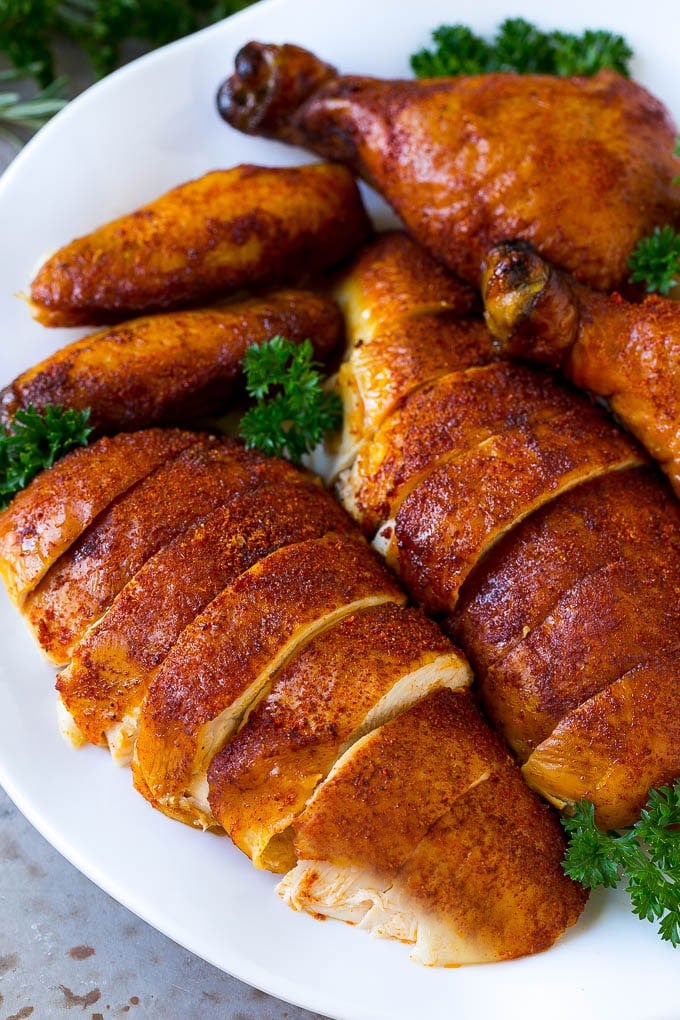 Smoked Chicken Recipe | Whole Smoked Chicken | BBQ Chicken #chicken #smoker #BBQ #dinner #jonep #glutenfree #lowcarb Carved smoked chicken including drumsticks, wings and chicken breasts on a serving platter.