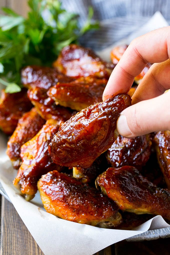 Smoked Chicken Wings | Barbecue Chicken Wings | BBQ Chicken Wings #chicken #wings #bbq #barbecue #appetizer #dinner #jonep A pile of smoked chicken wings with a hand reaching out for one.