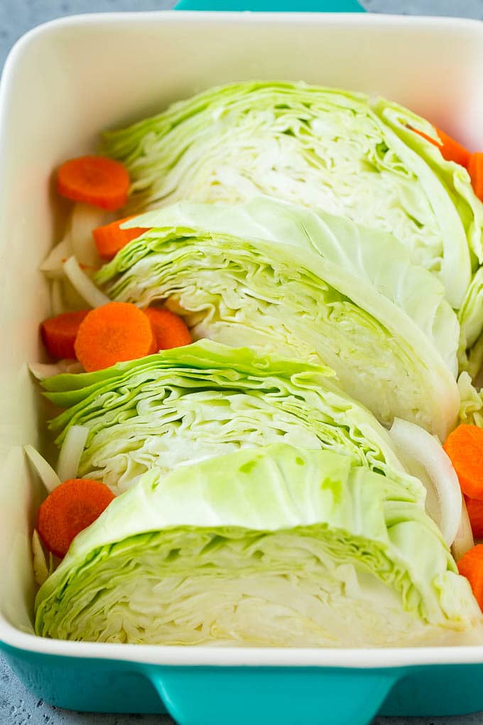 Braised Cabbage Recipe | Easy Cabbage Recipe #cabbage #lowcarb #keto #carrots #veggies #vegetarian #dinner #jonep Wedges of cabbage, sliced carrots and onion in a baking dish.