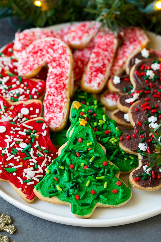 Christmas Sugar Cookies Recipe | Christmas Cookies #cookies #frosting #sprinkles #sugarcookies #christmas #dessert #jonep A serving plate of Christmas sugar cookies decorated with frosting and sprinkles.