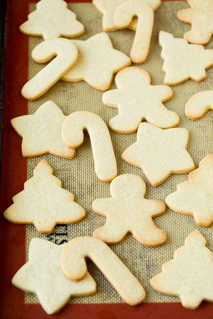 Christmas Sugar Cookies Recipe | Christmas Cookies #cookies #frosting #sprinkles #sugarcookies #christmas #dessert #jonep Cut out cookies on a sheet pan.