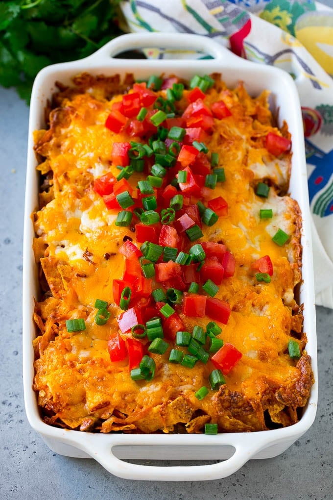 Dorito Casserole Recipe | Mexican Casserole | Beef Casserole #mexicanfood #beef #groundbeef #casserole #dinner #jonep Dorito casserole topped with melted cheese, diced tomatoes and sliced green onions.
