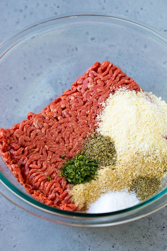 Italian Meatball Soup Recipe | Meatball Soup | Beef Meatballs #meatballs #beef #soup #italian #dinner #jonep #comfortfood Ground beef, breadcrumbs, parsley, herbs and parmesan cheese in a mixing bowl.