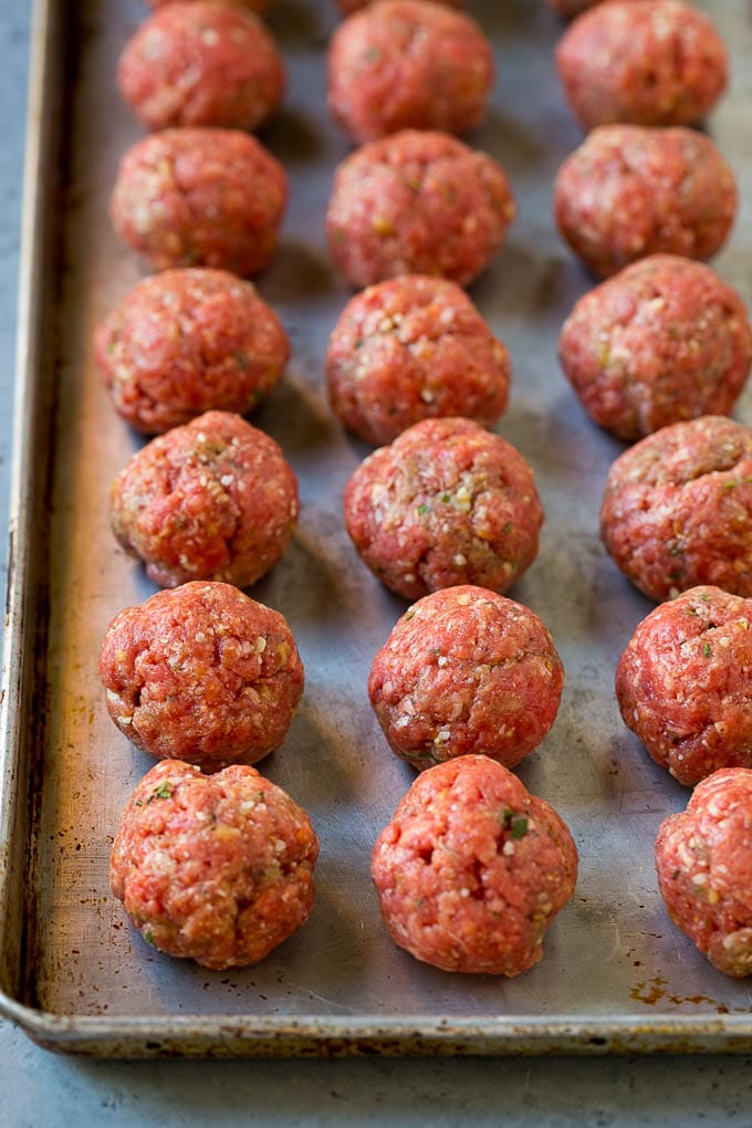 Italian Meatball Soup Recipe | Meatball Soup | Beef Meatballs #meatballs #beef #soup #italian #dinner #jonep #comfortfood Raw meatballs on a sheet pan ready to go into the oven.
