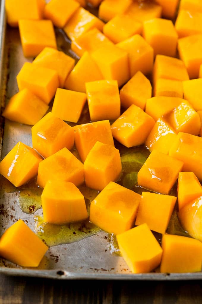 Roasted Butternut Squash Recipe | Baked Butternut Squash | Butternut Squash Side Dish #butternutsquash #squash #fall #vegetarian #dinner #jonep Cubes of winter squash coated in olive oil, brown sugar and maple syrup.