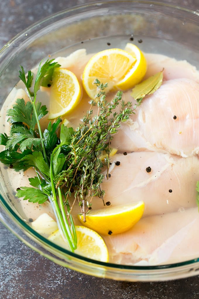 Smoked Chicken Breast Recipe | BBQ Chicken | Smoked Chicken #bbq #chicken #smoker #dinner #glutenfree #jonep Chicken breasts in a bowl of brine with lemon and herbs.