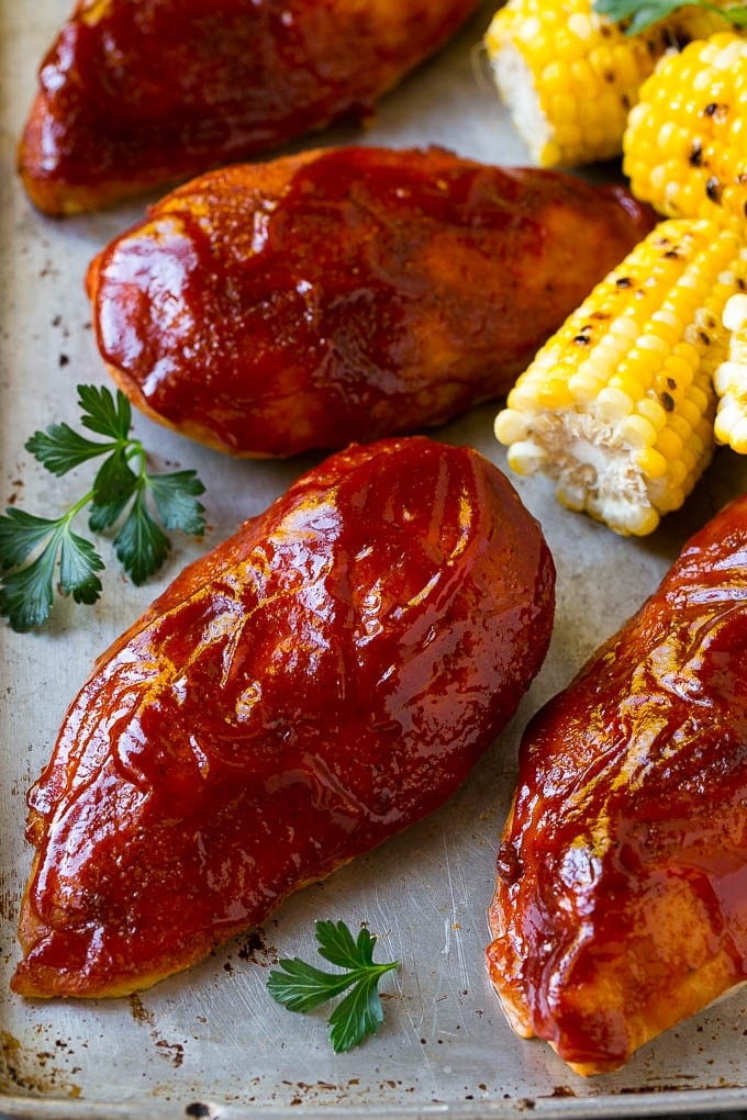 Smoked Chicken Breast Recipe | BBQ Chicken | Smoked Chicken #bbq #chicken #smoker #dinner #glutenfree #jonep Smoked chicken breasts on a sheet pan with corn on the corn and fresh herbs.