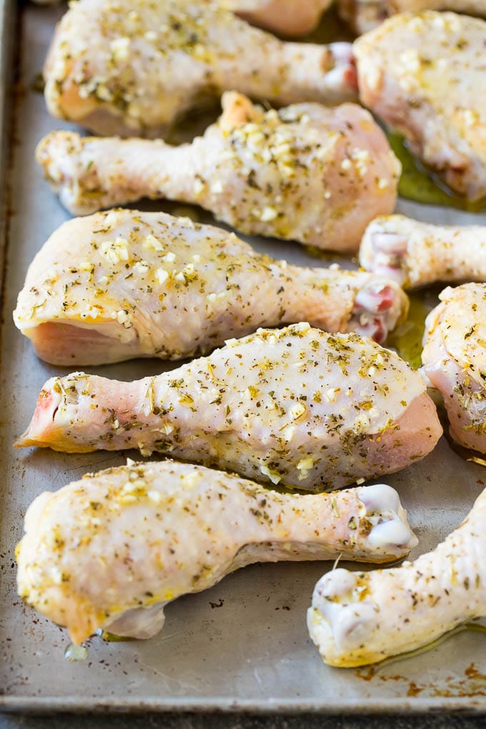 Baked Chicken Drumsticks Recipe | Roasted Chicken Drumsticks | Garlic and Herb Chicken #dinner #chicken #garlic #glutenfree #lowcarb #keto #cleaneating #jonep Marinated chicken legs on a sheet pan, ready to go into the oven.
