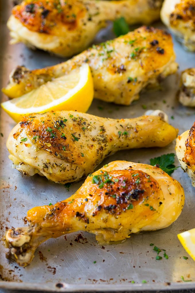 Baked Chicken Drumsticks Recipe | Roasted Chicken Drumsticks | Garlic and Herb Chicken #dinner #chicken #garlic #glutenfree #lowcarb #keto #cleaneating #jonep Baked chicken drumsticks flavored with garlic and herbs, then garnished with lemon wedges and parsley.