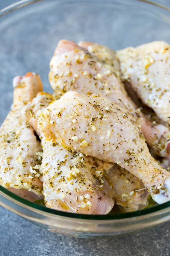 Baked Chicken Drumsticks Recipe | Roasted Chicken Drumsticks | Garlic and Herb Chicken #dinner #chicken #garlic #glutenfree #lowcarb #keto #cleaneating #jonep A bowl of chicken legs in a garlic and herb marinade.
