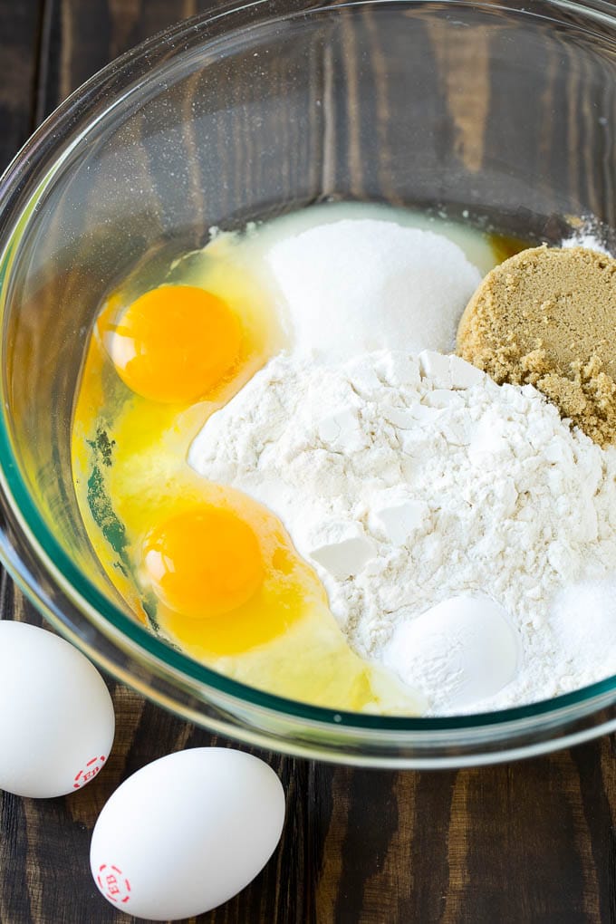 Baked Donuts Recipe | Cake Donuts | Chocolate Donuts | Sprinkle Donuts #donuts #chocolate #sprinkles #breakfast #brunch #jonep Flour, sugar, baking powder and eggs in a mixing bowl.