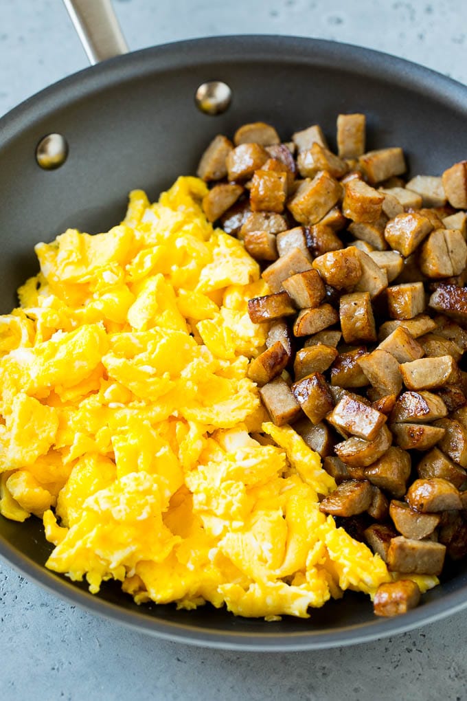 Breakfast Burrito Recipe | Sausage Breakfast Burrito #breakfast #sausage #eggs #burrito #jonep Diced sausage and scrambled eggs in a pan.