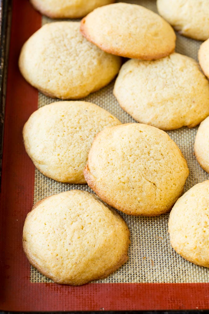 Eggnog Cookies Recipe | Holiday Cookies | Christmas Cookies #cookies #eggnog #baking #christmas #sprinkles #dessert #jonep Baked eggnog cookies on a sheet pan.