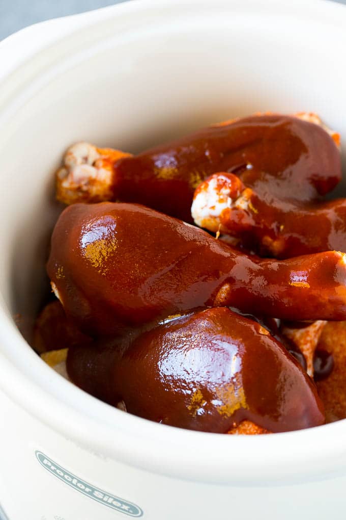 Slow Cooker Chicken Drumsticks Recipe | Crock Pot Chicken Drumsticks | BBQ Chicken Drumsticks #chicken #drumsticks #slowcooker #crockpot #bbq #dinner #jonep A crock pot of chicken drumsticks coated in BBQ sauce.