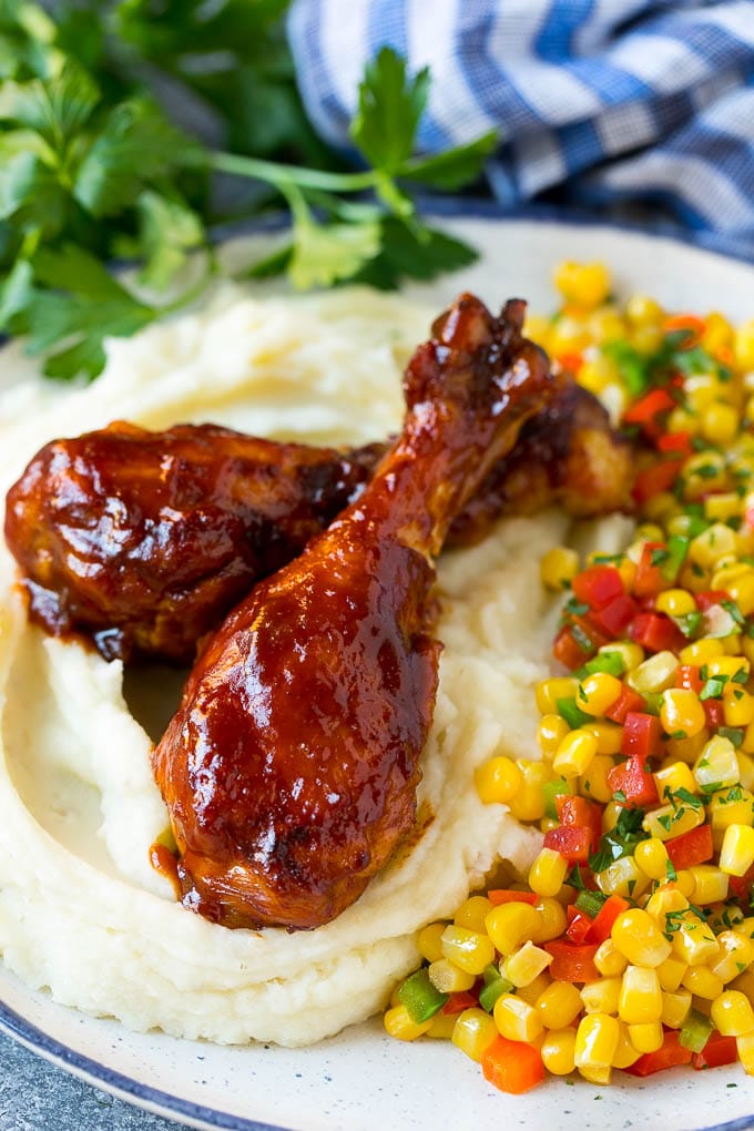 Slow Cooker Chicken Drumsticks Recipe | Crock Pot Chicken Drumsticks | BBQ Chicken Drumsticks #chicken #drumsticks #slowcooker #crockpot #bbq #dinner #jonep Slow cooker chicken drumsticks served with mashed potatoes and corn.