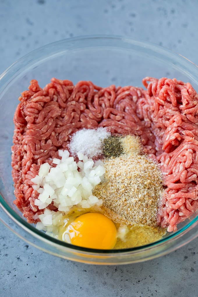 Sweet and Sour Meatballs Recipe | Slow Cooker Meatballs | Crockpot Meatballs | Cocktail Meatballs #meatballs #beef #slowcooker #crockpot #dinner #appetizer #jonep Ground beef, onion, breadcrumbs and seasonings in a bowl.