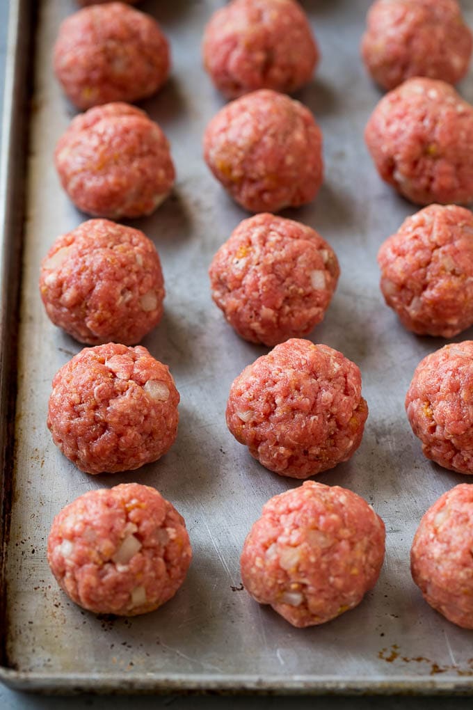 Sweet and Sour Meatballs Recipe | Slow Cooker Meatballs | Crockpot Meatballs | Cocktail Meatballs #meatballs #beef #slowcooker #crockpot #dinner #appetizer #jonep Homemade meatballs on a sheet pan.