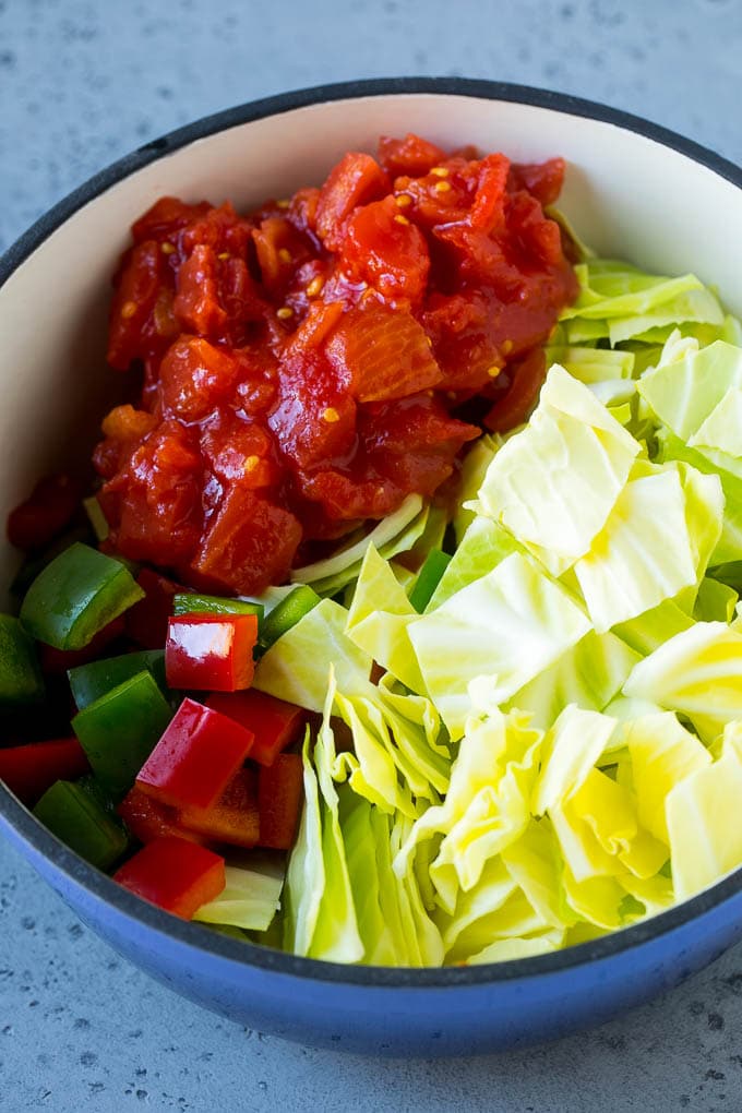 Cabbage Soup Recipe | Vegetable Soup | Veggie Soup | Healthy Soup #soup #healthy #cleaneating #cabbage #vegetables #veggies #dinner #jonep Red and green peppers, diced tomatoes and raw veggies in a large pot.