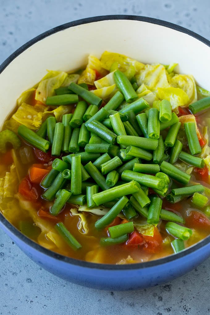 Cabbage Soup Recipe | Vegetable Soup | Veggie Soup | Healthy Soup #soup #healthy #cleaneating #cabbage #vegetables #veggies #dinner #jonep Green beans in a pot of cooked veggies.