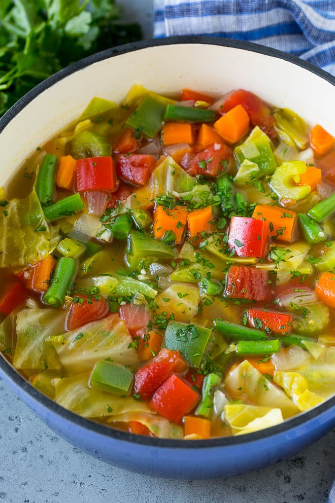 Cabbage Soup Recipe | Vegetable Soup | Veggie Soup | Healthy Soup #soup #healthy #cleaneating #cabbage #vegetables #veggies #dinner #jonep A pot of cabbage soup with carrots, celery, bell peppers and green beans.