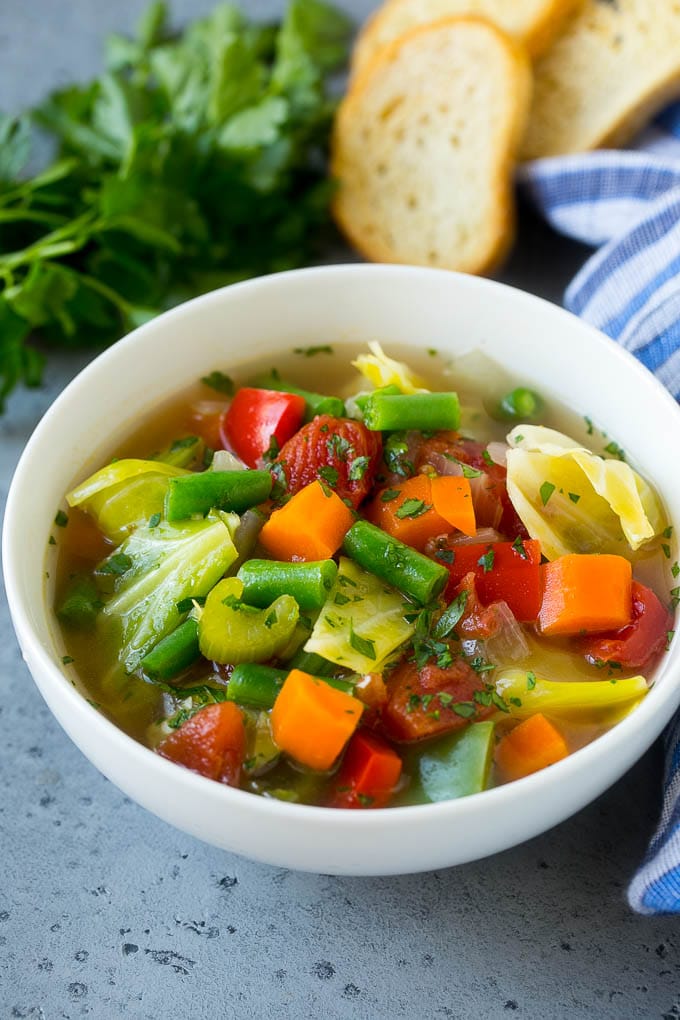 Cabbage Soup Recipe | Vegetable Soup | Veggie Soup | Healthy Soup #soup #healthy #cleaneating #cabbage #vegetables #veggies #dinner #jonep A bowl of cabbage soup with carrots, celery and tomatoes in broth.