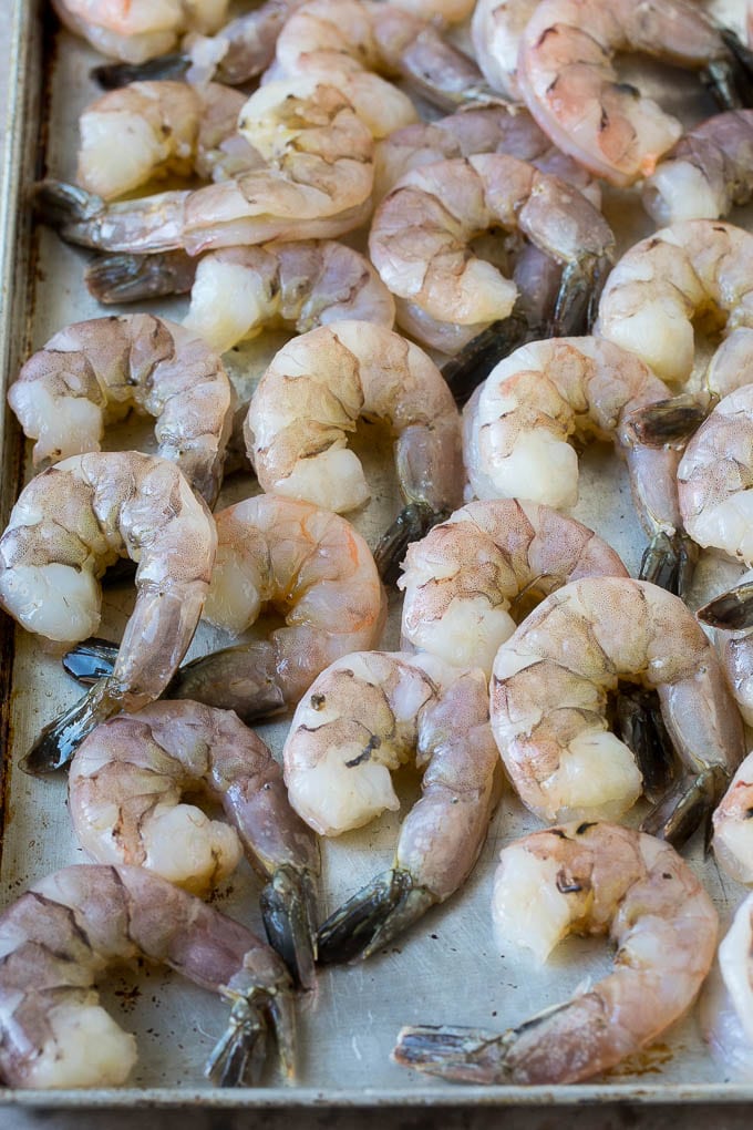 Coconut Shrimp Recipe | Fried Shrimp | Shrimp Appetizer #shrimp #coconut #appetizer #seafood #dinner #jonep Large raw tail-on shrimp arranged on a sheet pan.