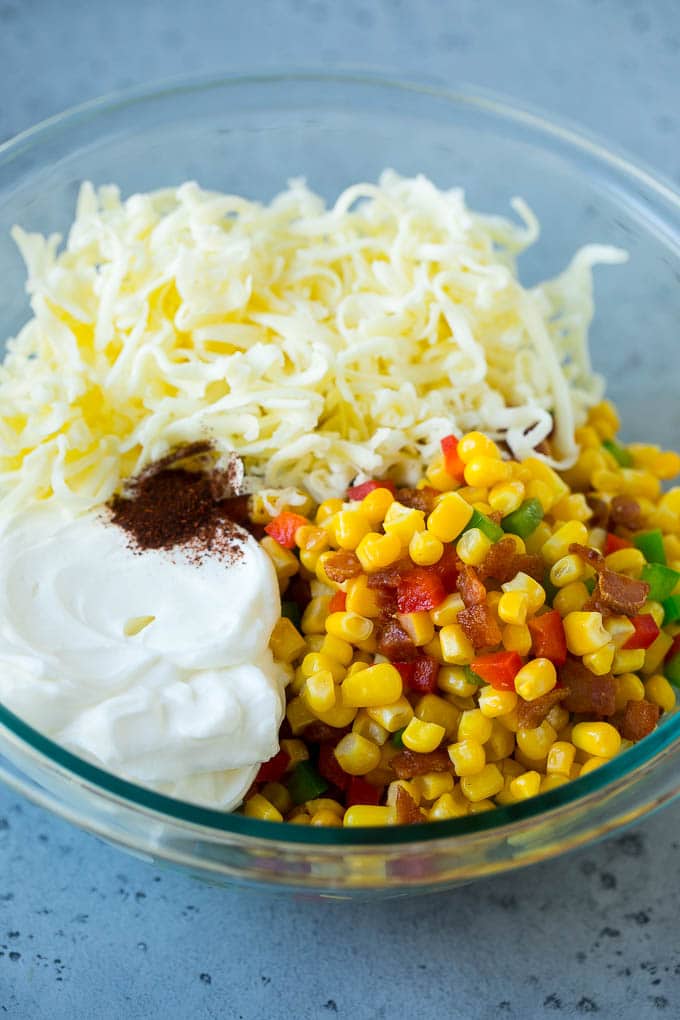 Corn Dip Recipe | Hot Cheese Dip | Bacon Dip #corn #dip #bacon #cheese #appetizer #snack #jonep Corn, bacon, bell peppers, sour cream and cheese in a mixing bowl.