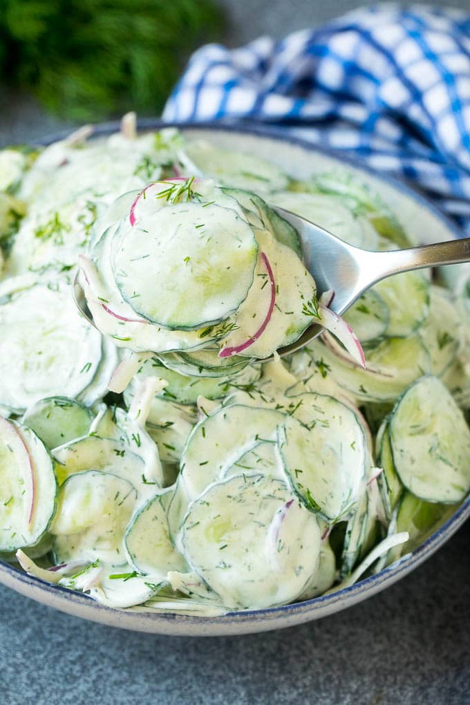 Creamy Cucumber Salad Recipe | German Cucumber Salad | Cucumber Salad #cucumber #salad #dinner #lunch #jonep #cucumbersalad A spoon serving up a portion of creamy cucumber salad.