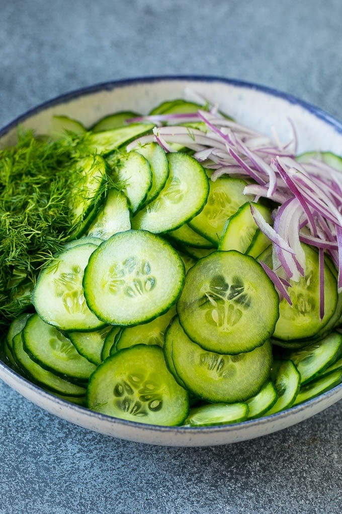 Cucumber Salad Recipe | Cucumber Dill Salad | Cucumber Recipe #cucumbers #salad #glutenfree #sidedish #jonep Ingredients including red onion and dill in a bowl.