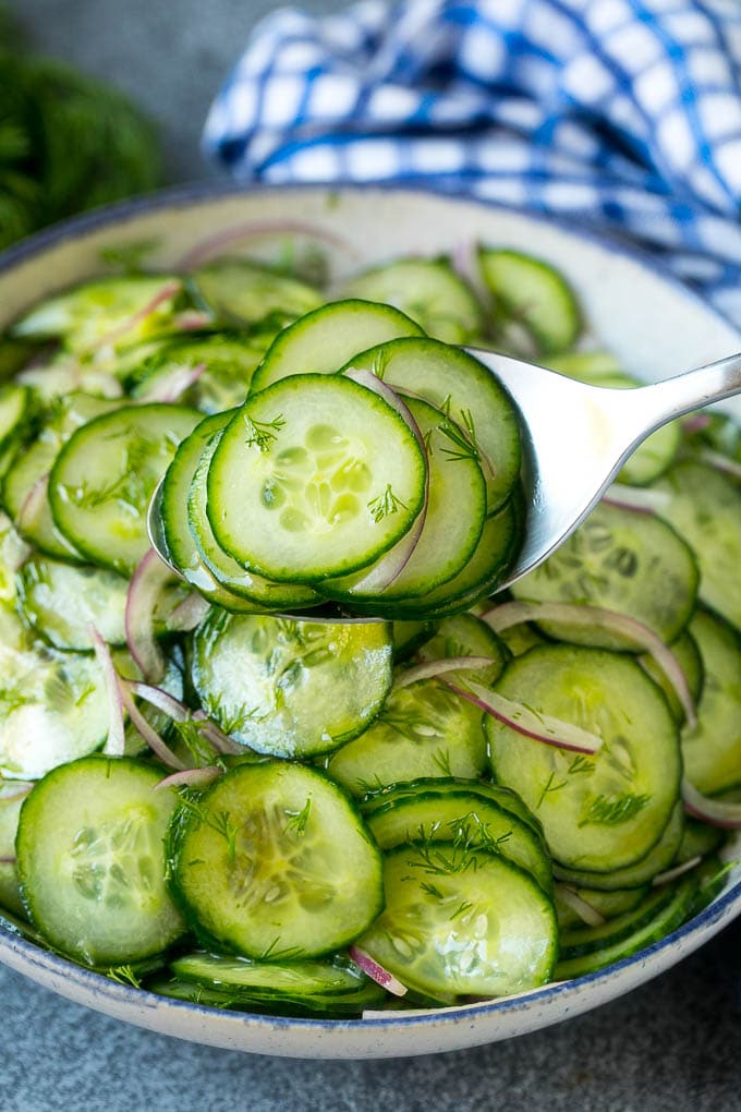 Cucumber Salad Recipe | Cucumber Dill Salad | Cucumber Recipe #cucumbers #salad #glutenfree #sidedish #jonep A spoon serving up a portion of classic cucumber salad.