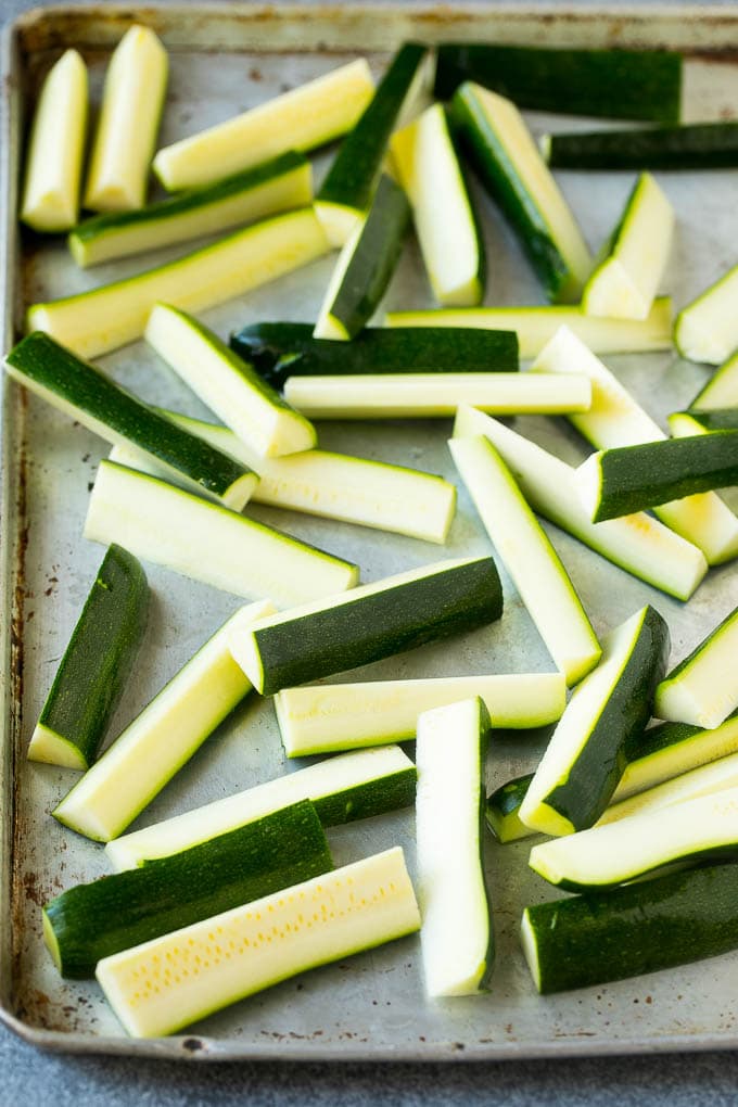 Fried Zucchini Recipe | Zucchini Fries | Zucchini Recipe #appetizer #zucchini #snack #jonep Raw sticks on a sheet pan.