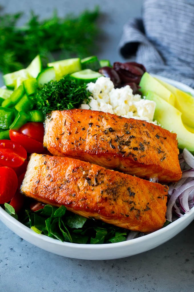 Greek Salmon Salad Recipe | Low Carb Salmon Recipe | Salmon Salad #salmon #seafood #fish #lowcarb #keto #lunch #jonep #healthy Salmon fillets on lettuce with tomatoes, feta cheese, avocado, olives, cucumbers and herbs.